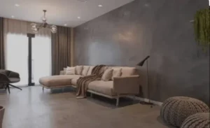 Sala de estar moderna com cimento queimado para parede e piso, acabamento elegante da Casa da Textura.