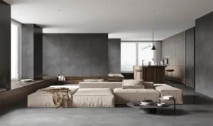 Sala de estar integrada à cozinha com cimento queimado para parede e piso, acabamento moderno e elegante da Casa da Textura.